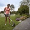 using worx trimmer to edge the side of grass and sidewalk