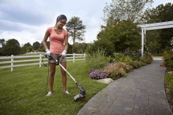 using worx trimmer to edge the side of grass and sidewalk