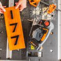 jigsaw next to cut out of door number sign on top of pegaus worktable