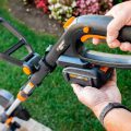 battery being inserted to top of worx trimmer