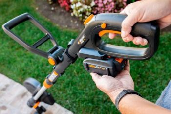 battery being inserted to top of worx trimmer