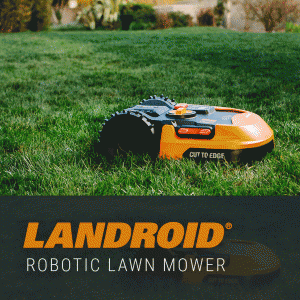 orange and black landroid robotic lawn mower cutting green grass