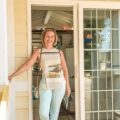women standing in front of open glass door