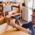 sanding the side of wooden plant holder