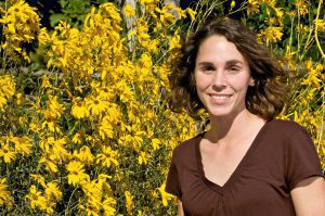 Kim Toscano in front of yellow planted flower