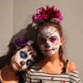 two girls with painted skeleton face