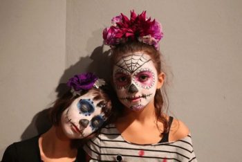 two girls with painted skeleton face