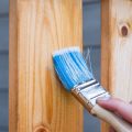 paint brush staining wood deck railing