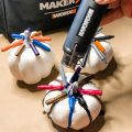 heat gun heating crayons on top of white pumpkins