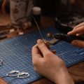 hand holding rotary tool cutting wire