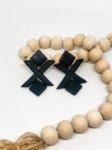 wooden necklace beads next to black x earings