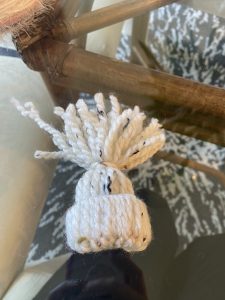 finished yarn weaved hat on clear table