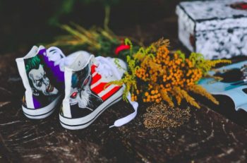 air brush painted shoes next to orange flowers