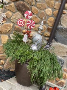 small silver ornaments in green planted pot