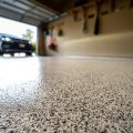 clean garage floor with garage door open and car entering