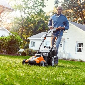 man mowing lawn with battery powered lawn mower from Worx