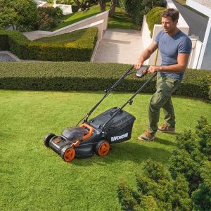 man mowing lawn with Worx WG779 cordless lawn mower