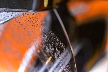 close up of rain droplets on car