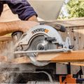 person using Worx circular saw to cut board