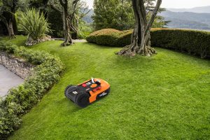 Landroid robotic lawn mower mowing lawn on a slope