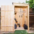 DIY Shed thats storing blower, trimmer, and snipping garden tools