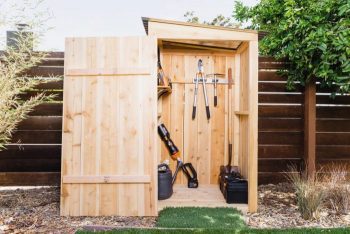 DIY Shed thats storing blower, trimmer, and snipping garden tools