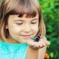 Child With A Butterfly. Selective Focus.