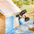 using paintsprayer to paint side of dog house blue
