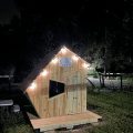 Front view of angled wood built house with door and window
