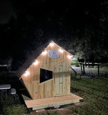 Front view of angled wood built house with door and window