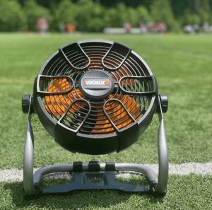 worx fan sitting on green grass with white line