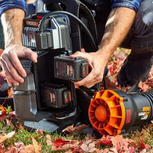 inserting batteries into backpack leaf blower