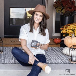 profile picture of Taryn Whiteacre sitting front door steps next to pumpkins