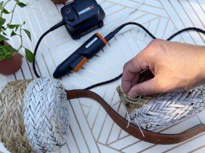 hand is threading cotton string through belt holes