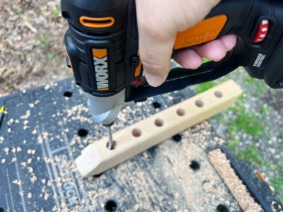 using worx drill to drill holes into wooden block