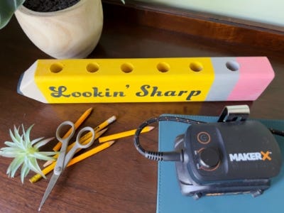 wooden yellow pencil holder sitting on desk