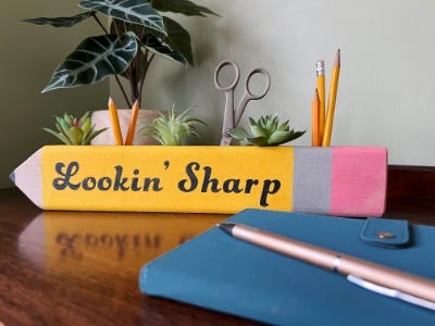 wooden yellow pencil holder sitting on desk front view