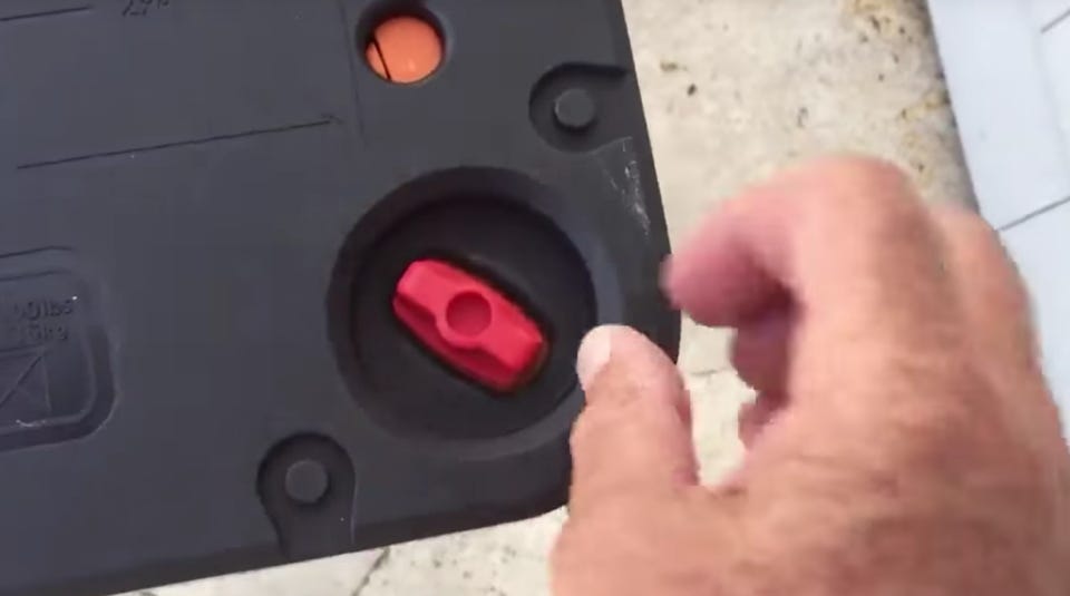 person securing the red knob