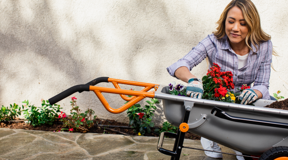 Aerocart Flower Planting woman using Worx Aerocart to plant flower garden bed