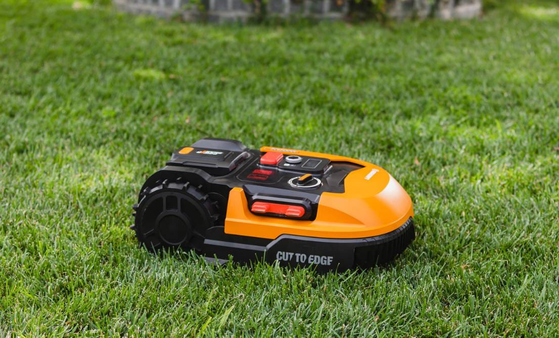 Orange Worx landroid cutting grass