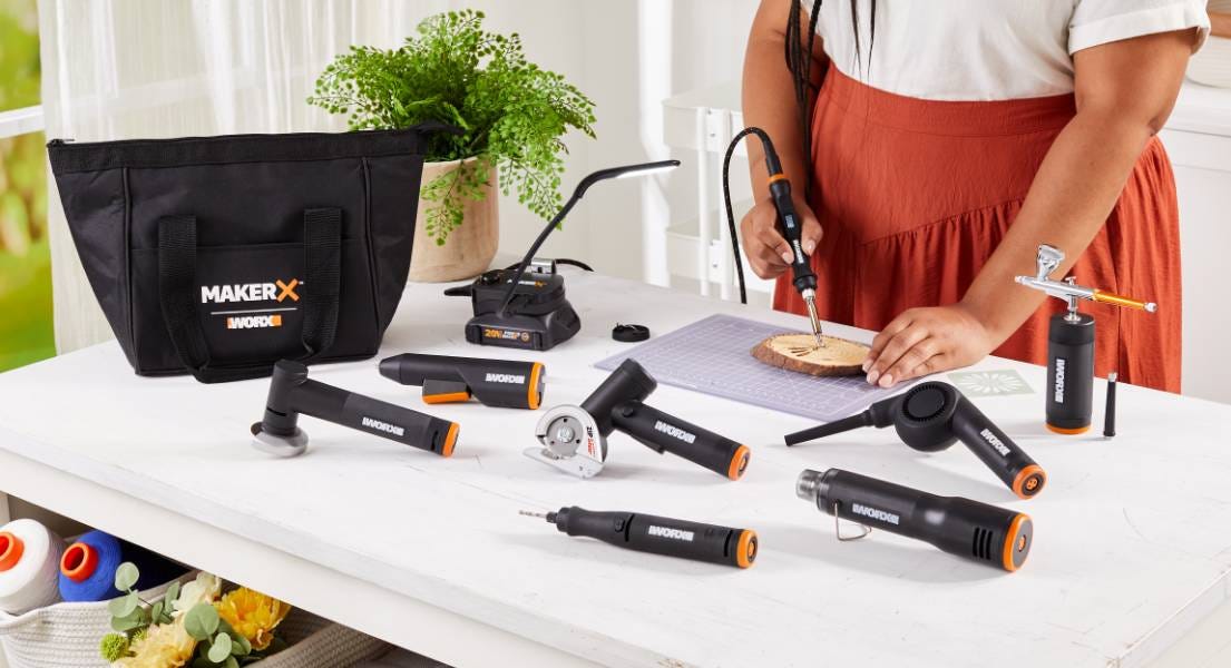 Wood engraving with MakerX tool surrounded by other makerx tools on table