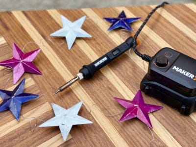 silver red and blue stars on wooden table with soldering tool