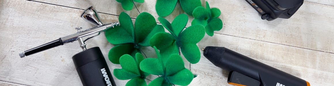 air brush mini glue gun next to four leaf clover felt decoration