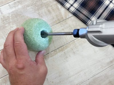 drill drilling hole into top and bottom of foam ball