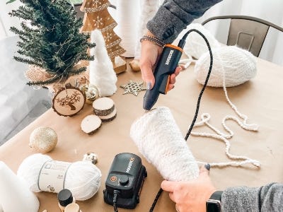 hot glue gun glueing bottom of yarn tree