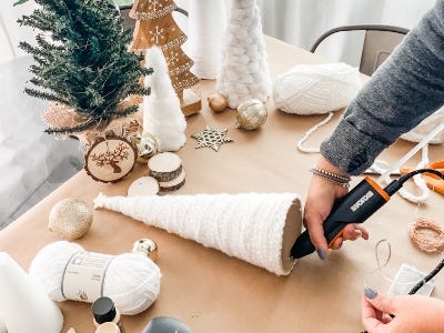 using the hot glue gun to glue the inside of the yard cone