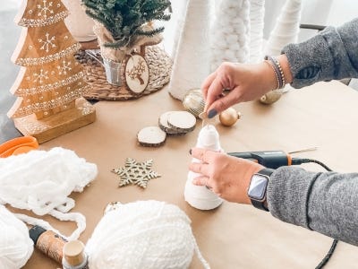 placing wooden star on top of smaller yarn tree