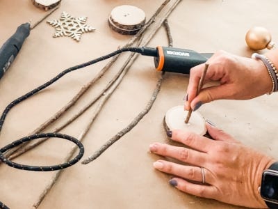 inserting stick into stand with hot glue 