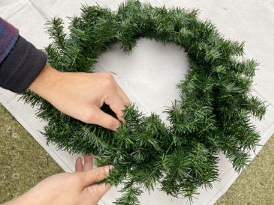 placing wreath on top of tarp