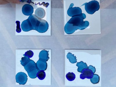 different shades of blue spots splattered on coasters